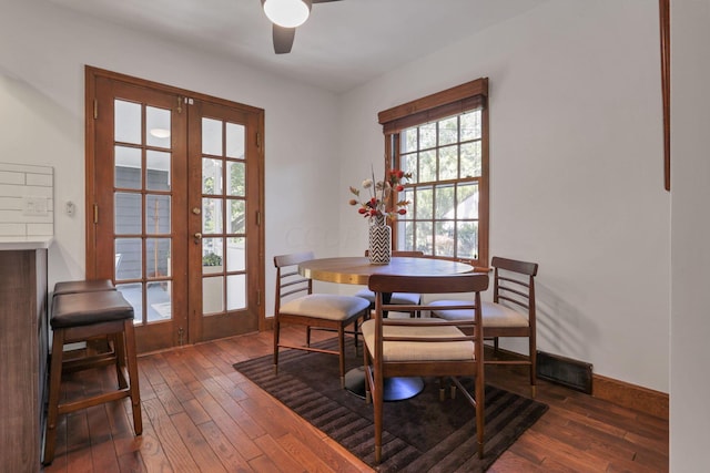 dining area featuring ceiling fan, dark hardwood / wood-style flooring, and french doors