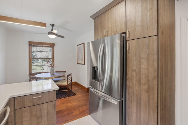 kitchen with ceiling fan, stainless steel fridge, wood-type flooring, and dishwashing machine