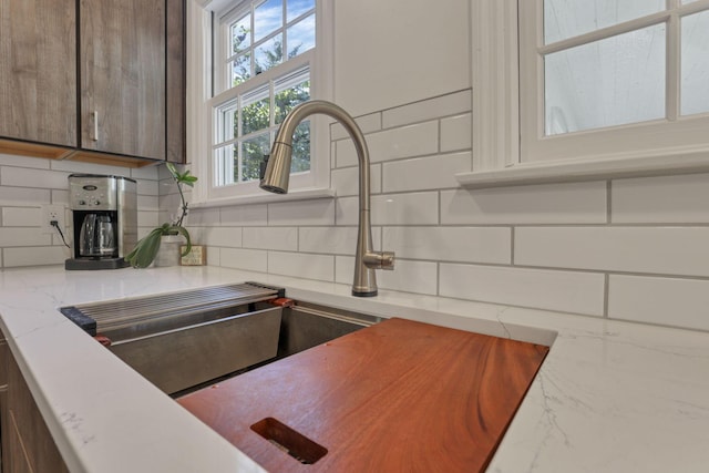 kitchen featuring backsplash and sink