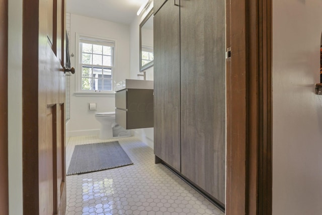 bathroom featuring tile patterned floors, vanity, and toilet