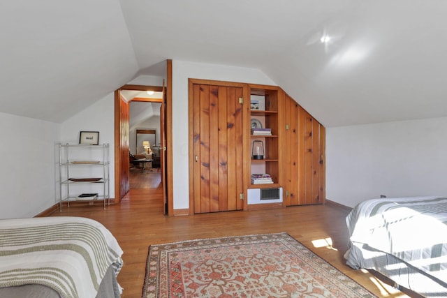 bedroom featuring hardwood / wood-style floors and vaulted ceiling