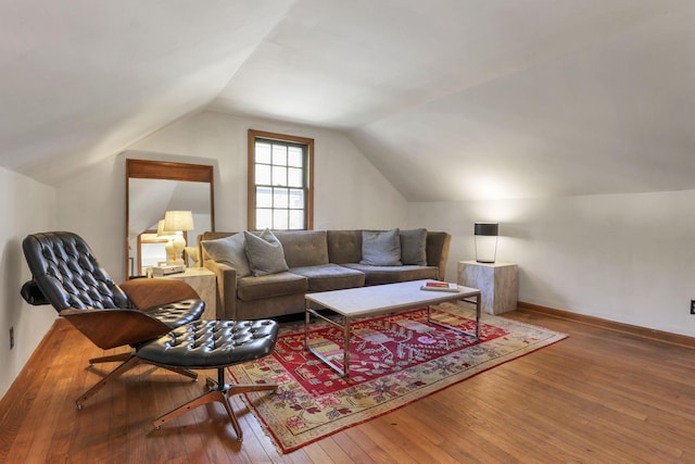 living room featuring hardwood / wood-style flooring and vaulted ceiling