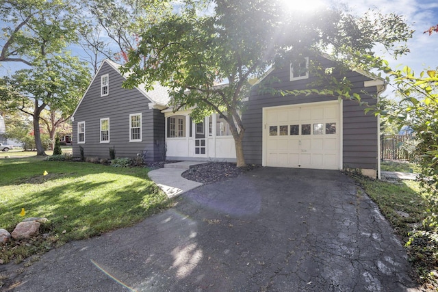 view of front of property featuring a garage and a front lawn