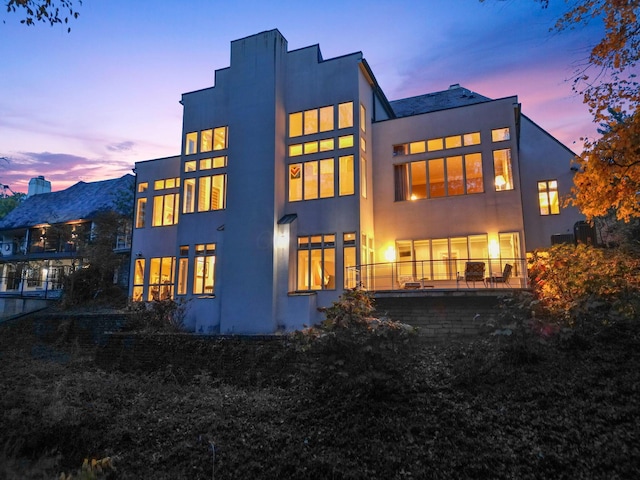 view of back house at dusk