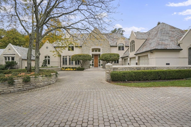 french country inspired facade featuring a garage