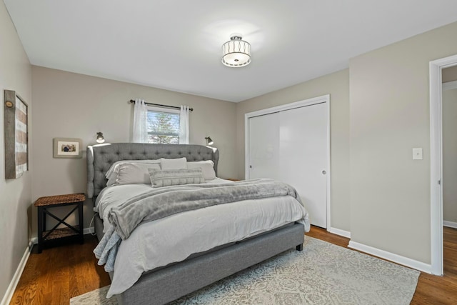 bedroom featuring a closet, baseboards, and wood finished floors