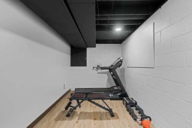 exercise room featuring wood finished floors
