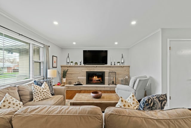 living room featuring crown molding, a fireplace, and recessed lighting