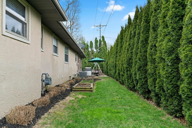 view of yard with central AC and a vegetable garden