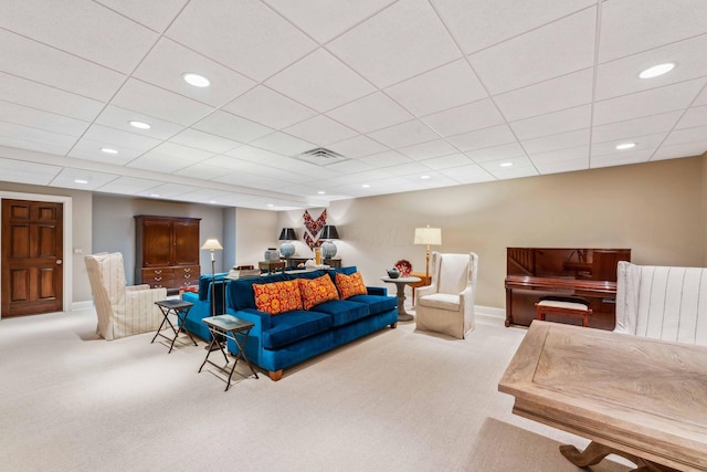 carpeted living room with a paneled ceiling