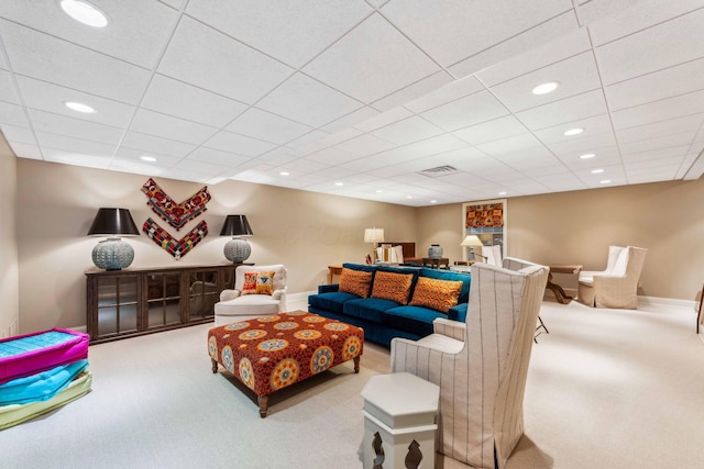 carpeted living room featuring a paneled ceiling