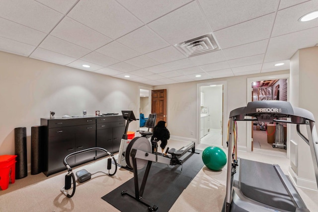 exercise room featuring light colored carpet and a drop ceiling