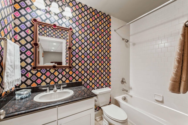 full bathroom featuring vanity, toilet, and tiled shower / bath