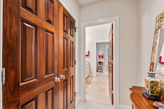 hallway featuring light tile patterned flooring