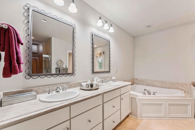 bathroom with tile patterned flooring, a bath, and vanity