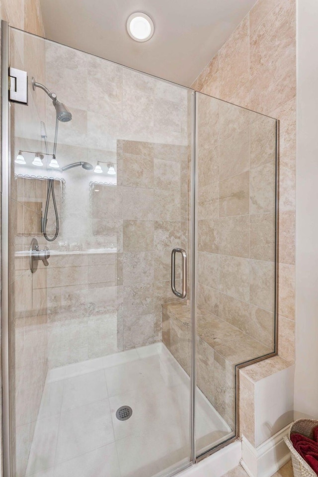 bathroom with tile patterned floors and walk in shower