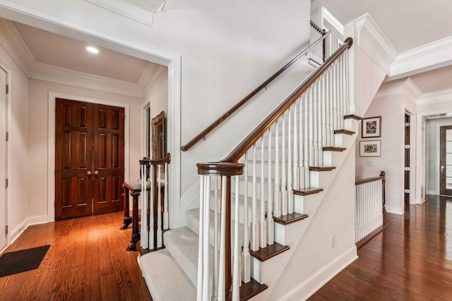 foyer entrance with dark hardwood / wood-style flooring and ornamental molding