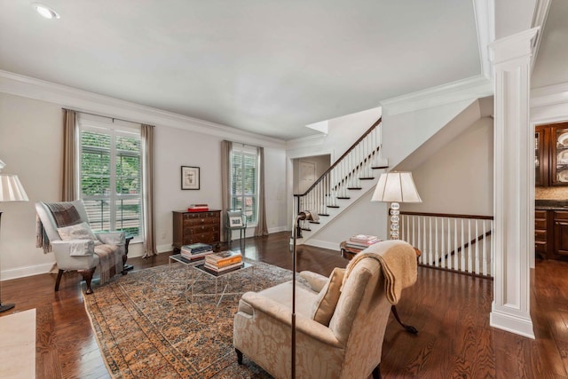 living room featuring ornate columns, crown molding, and dark hardwood / wood-style floors