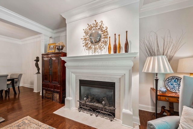 living area with ornamental molding and dark wood-type flooring