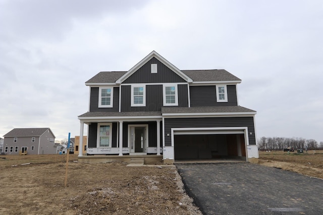 view of front facade featuring covered porch and a garage