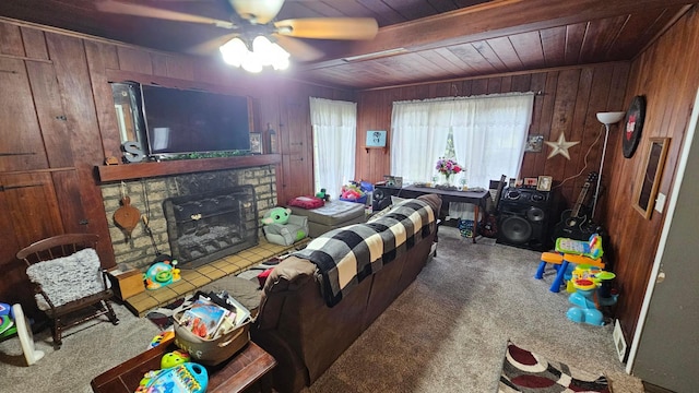 3483 State Route 257, Ostrander, OH 43061 - carpeted living room featuring a stone fireplace, ceiling fan, wooden ceiling, and wood walls