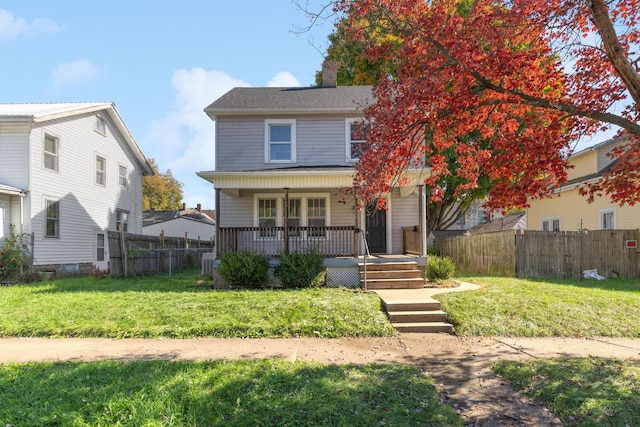 view of front of property featuring covered porch and a front yard