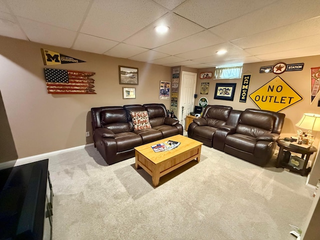 carpeted living room with a paneled ceiling