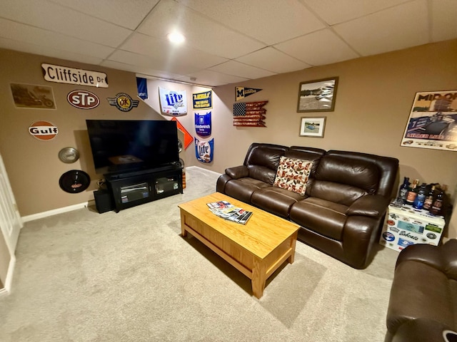 living room with a drop ceiling and carpet floors