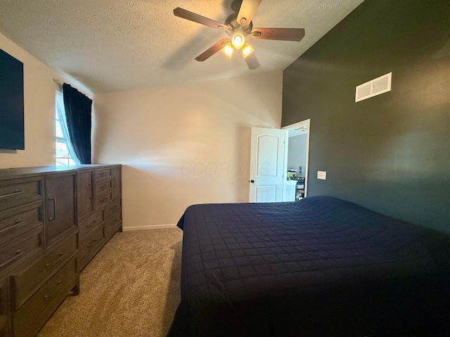 carpeted bedroom featuring ceiling fan, a textured ceiling, and vaulted ceiling