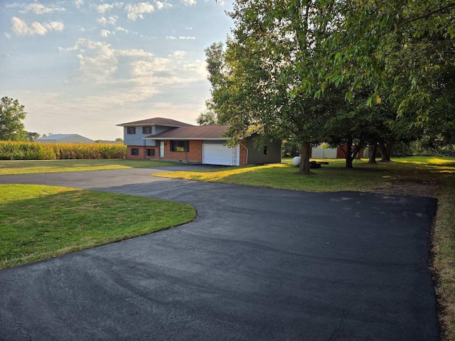 view of front facade with a mountain view, a garage, and a front lawn