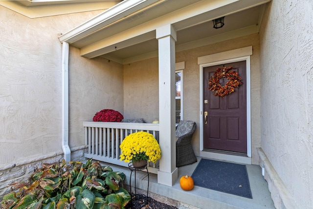 entrance to property featuring a porch