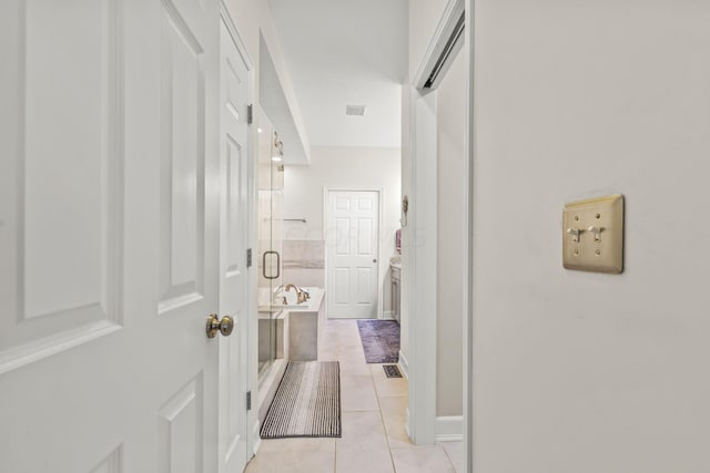 hallway featuring light tile patterned floors