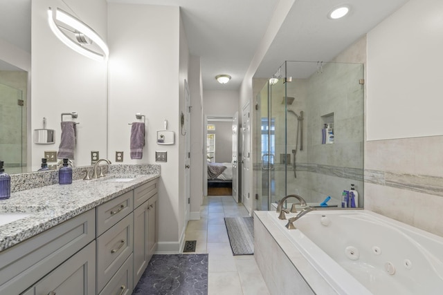 bathroom with tile patterned floors, vanity, and separate shower and tub