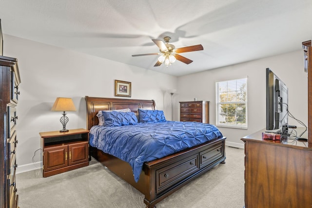 bedroom featuring light colored carpet and ceiling fan