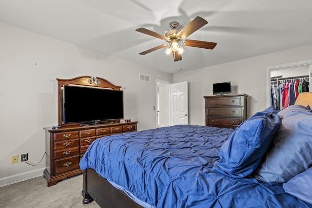 carpeted bedroom with a closet and ceiling fan