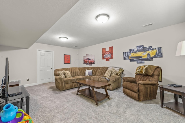 carpeted living room featuring a textured ceiling