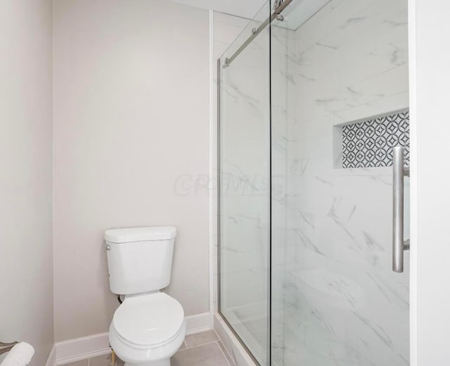 bathroom with an enclosed shower, tile patterned flooring, and toilet