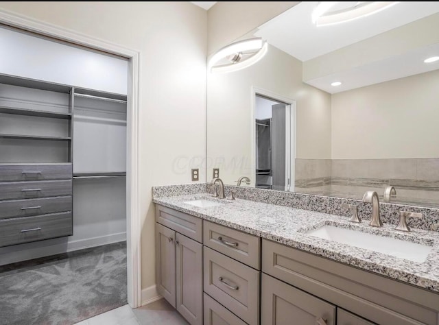 bathroom featuring tile patterned flooring and vanity