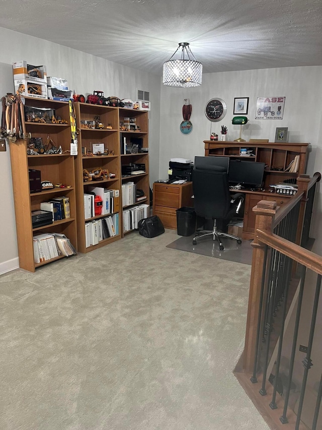 office area featuring carpet floors and a textured ceiling