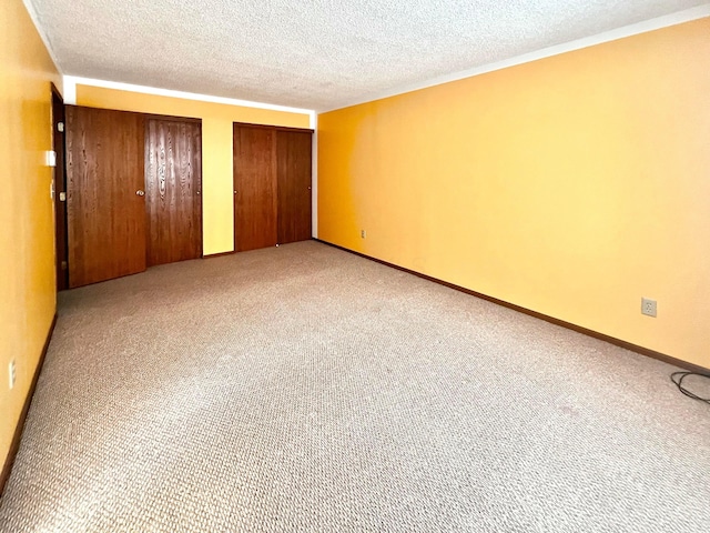 unfurnished bedroom featuring light colored carpet and a textured ceiling