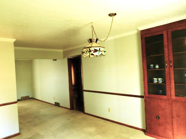 carpeted empty room featuring ornamental molding