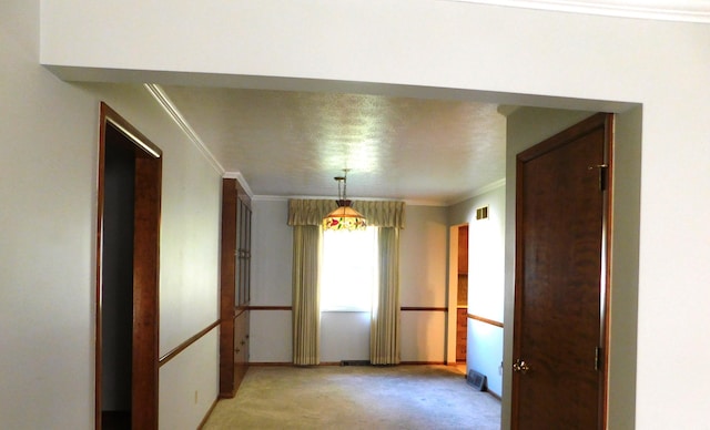 unfurnished dining area with crown molding and light carpet