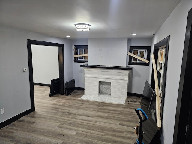 unfurnished living room with hardwood / wood-style floors and a fireplace