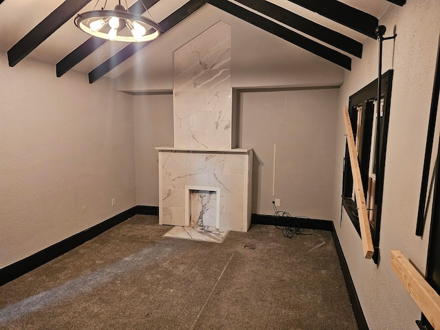 interior space featuring beam ceiling, carpet floors, and a tile fireplace