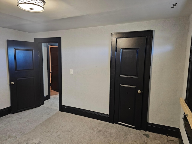 bedroom featuring light carpet