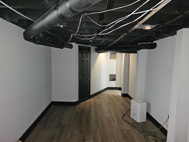 basement featuring dark hardwood / wood-style floors