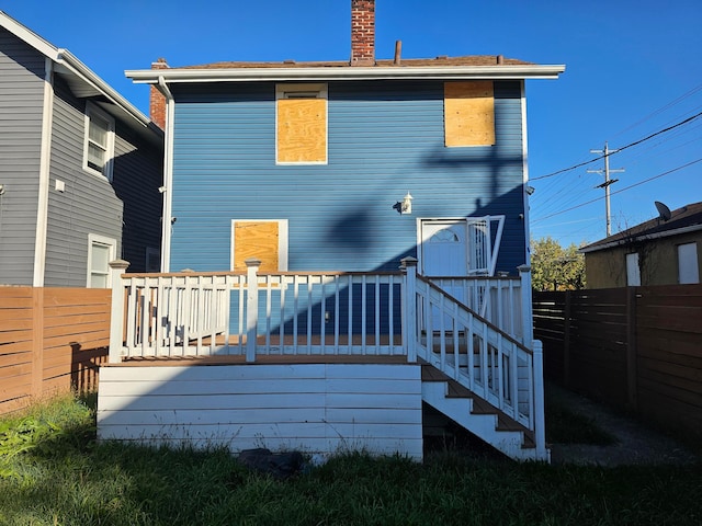 rear view of house featuring a wooden deck