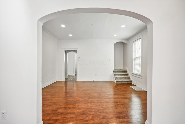 unfurnished room with dark hardwood / wood-style flooring and ornamental molding