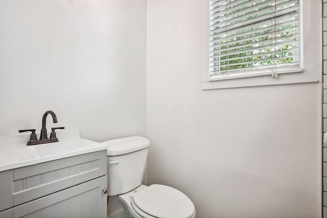 bathroom featuring toilet and vanity