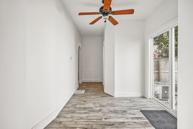 unfurnished room with light wood-type flooring and ceiling fan